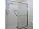 Clean white shower featuring tile surround, shower head, and grab bar at 6462 River Run Blvd, Weeki Wachee, FL 34607