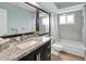 Updated bathroom with a granite countertop and bathtub shower combination at 7230 Hummingbird Ln, New Port Richey, FL 34655