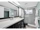 Modern bathroom featuring a sleek vanity, shower, and tile at 7230 Hummingbird Ln, New Port Richey, FL 34655