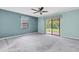 Bedroom with sliding glass door and neutral carpet at 7230 Hummingbird Ln, New Port Richey, FL 34655