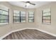 Bright room with multiple windows and wood-look flooring at 7230 Hummingbird Ln, New Port Richey, FL 34655