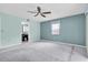 Spacious bedroom with a view of the kitchen and carpeting at 7230 Hummingbird Ln, New Port Richey, FL 34655