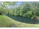 Tranquil creek view showcasing lush green banks and mature trees creating a serene natural backdrop at 7230 Hummingbird Ln, New Port Richey, FL 34655