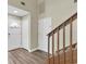 Bright foyer featuring wood-look floors, staircase and neutral walls at 7230 Hummingbird Ln, New Port Richey, FL 34655