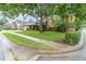 Charming home featuring a lush front yard, mature trees, and a well-maintained sidewalk at 7230 Hummingbird Ln, New Port Richey, FL 34655