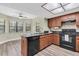 Bright kitchen showcasing granite countertops, a large window, and stainless steel appliances at 7230 Hummingbird Ln, New Port Richey, FL 34655