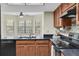 Kitchen with granite counters and stainless steel appliances, next to a breakfast nook at 7230 Hummingbird Ln, New Port Richey, FL 34655