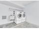 Bright laundry room featuring modern appliances including a washing machine and dryer at 7230 Hummingbird Ln, New Port Richey, FL 34655