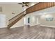 Expansive living room featuring wood floors, a staircase, and neutral walls for versatile decorating at 7230 Hummingbird Ln, New Port Richey, FL 34655