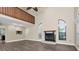Spacious living room with wood floors, a cozy fireplace, high ceilings and plentiful natural light at 7230 Hummingbird Ln, New Port Richey, FL 34655