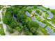 Aerial view of property surrounded by lush greenery and a creek at 7700 Danube Dr # 7700, Hudson, FL 34667