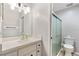 Bright bathroom with a single sink vanity, white cabinets, and a glass door shower at 7700 Danube Dr # 7700, Hudson, FL 34667