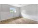 Neutral bedroom featuring carpet, white walls, and a large window with natural light at 7700 Danube Dr # 7700, Hudson, FL 34667
