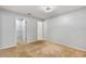 Neutral bedroom featuring carpet, white walls, ceiling light, and doors to closets at 7700 Danube Dr # 7700, Hudson, FL 34667