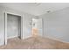 Bedroom featuring carpet, white walls, and doors to hallway and closets at 7700 Danube Dr # 7700, Hudson, FL 34667