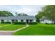 Charming single story home featuring a well-manicured lawn and neatly trimmed shrubs at 7700 Danube Dr # 7700, Hudson, FL 34667