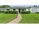 Charming single-story home with a well-manicured lawn and lush green hedges along the walkway at 7700 Danube Dr # 7700, Hudson, FL 34667