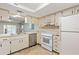 Open kitchen view highlighting stainless steel dishwasher and seamlessly connected living space at 7700 Danube Dr # 7700, Hudson, FL 34667