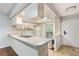 Well-lit kitchen with a functional layout, breakfast bar, and easy access to other rooms at 7700 Danube Dr # 7700, Hudson, FL 34667