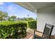 Relaxing front porch with a rocking chair, hedges, and view of the neighborhood at 7700 Danube Dr # 7700, Hudson, FL 34667