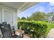 Relaxing front porch with a rocking chair and well-maintained hedges at 7700 Danube Dr # 7700, Hudson, FL 34667