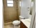 A tiled bathroom with a shower and vanity, complete with fixtures at 7714 Fox Hollow Dr, Port Richey, FL 34668