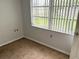 A bedroom with a window and blinds, offering natural light at 7714 Fox Hollow Dr, Port Richey, FL 34668