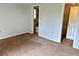 Bedroom featuring carpeted floors, a closet, and an attached bathroom at 7714 Fox Hollow Dr, Port Richey, FL 34668