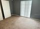 A bedroom with a window and ample space with carpet flooring at 7714 Fox Hollow Dr, Port Richey, FL 34668