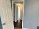A hallway showing doorways and closet with shelves, offering storage solutions at 7714 Fox Hollow Dr, Port Richey, FL 34668