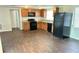 Bright kitchen featuring wooden cabinets and black appliances at 7714 Fox Hollow Dr, Port Richey, FL 34668