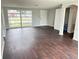 Living room with hardwood floors and large windows providing lots of light at 7714 Fox Hollow Dr, Port Richey, FL 34668