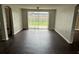 Spacious living room featuring hardwood floors and a sliding glass door at 7714 Fox Hollow Dr, Port Richey, FL 34668