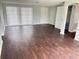 Bright living room featuring wood floors and a closet at 7714 Fox Hollow Dr, Port Richey, FL 34668