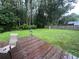 A view of the backyard from the deck, featuring a lush green lawn at 8122 Matthew Dr, New Port Richey, FL 34653