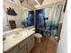 The bathroom features a ship-themed shower curtain and tile floors at 8122 Matthew Dr, New Port Richey, FL 34653