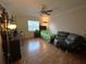 Cozy bedroom with hardwood floors, ceiling fan, and natural light at 8122 Matthew Dr, New Port Richey, FL 34653
