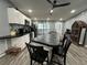 Modern kitchen with a large island, black countertops, white cabinets, and stainless steel appliances at 8122 Matthew Dr, New Port Richey, FL 34653
