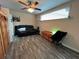The living room has wood floors and a reclining love seat at 8122 Matthew Dr, New Port Richey, FL 34653