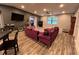 Spacious living room featuring hardwood floors, recessed lighting, modern furnishings, and a ceiling fan at 8122 Matthew Dr, New Port Richey, FL 34653