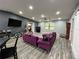 Spacious living room with hardwood floors, recessed lighting, modern furnishings, and a ceiling fan at 8122 Matthew Dr, New Port Richey, FL 34653