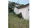 Backyard featuring the side of the house with AC unit and partial fencing at 8516 Inwood Dr, Hudson, FL 34667