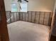 Bedroom stripped bare, showing studs, concrete blocks, and a window, ready for renovation at 8516 Inwood Dr, Hudson, FL 34667
