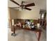 Dining room showing damaged drywall and exposed studs and a ceiling fan at 8516 Inwood Dr, Hudson, FL 34667