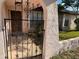 Exterior view of home showcasing the arched entryway and wrought iron gate leading to the front door at 8516 Inwood Dr, Hudson, FL 34667