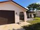 Charming home featuring an arched entryway with a wrought iron gate and a one-car garage at 8516 Inwood Dr, Hudson, FL 34667