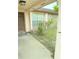 View of front porch with the entrance door and a stone facade detail at 8516 Inwood Dr, Hudson, FL 34667