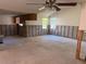 View of the damaged living room with concrete floors and exposed studs at 8516 Inwood Dr, Hudson, FL 34667