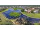Scenic aerial view of community with waterfront homes, lush greenery and lakes at 9188 Mississippi Run, Weeki Wachee, FL 34613