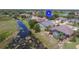 Neighborhood aerial view of homes situated along a lake with private pools and lush landscaping at 9188 Mississippi Run, Weeki Wachee, FL 34613